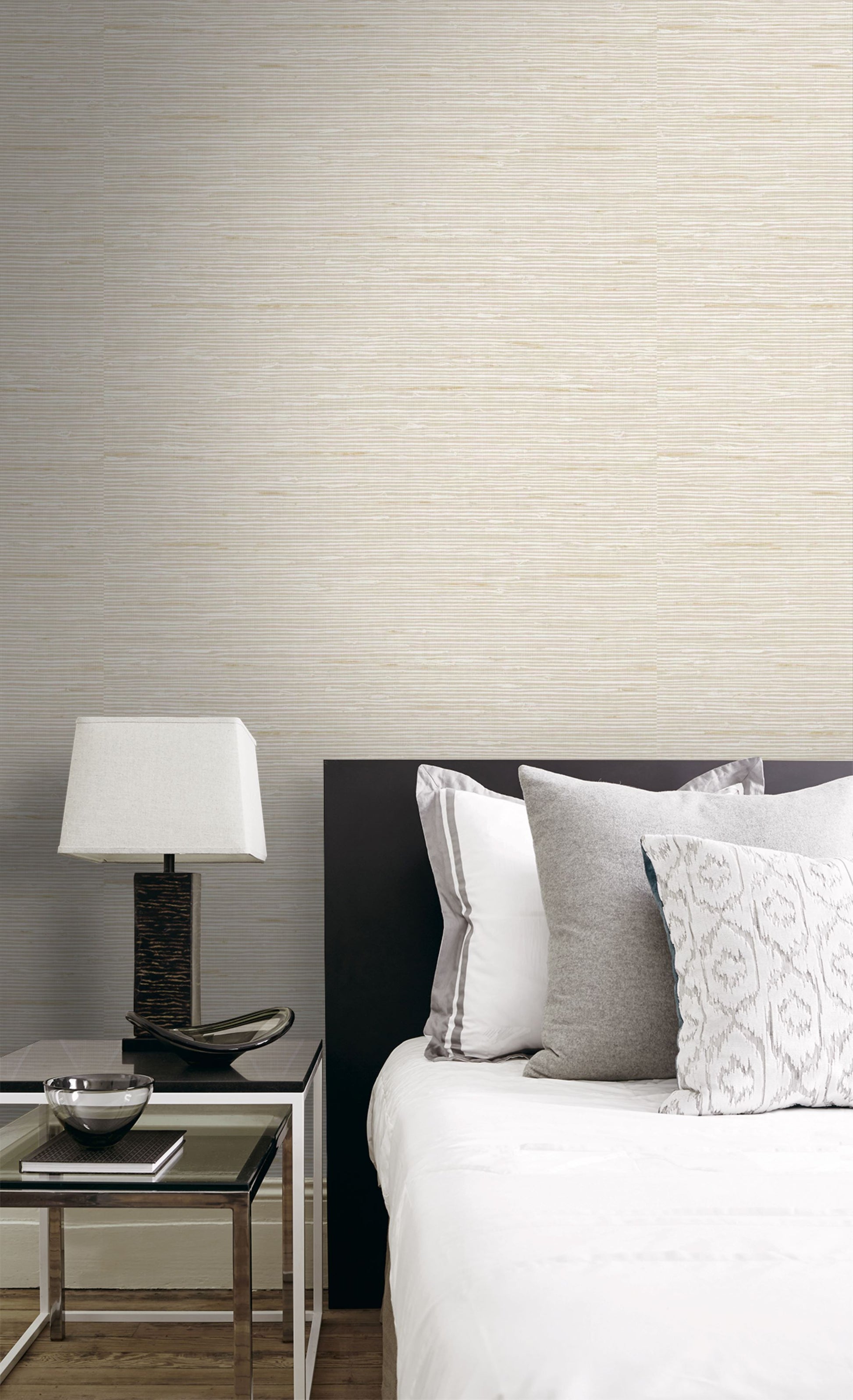 Bedroom with a bed and nightstand against a wall decorated with Sun Beige Natural Weave Commercial & Vinyl.
