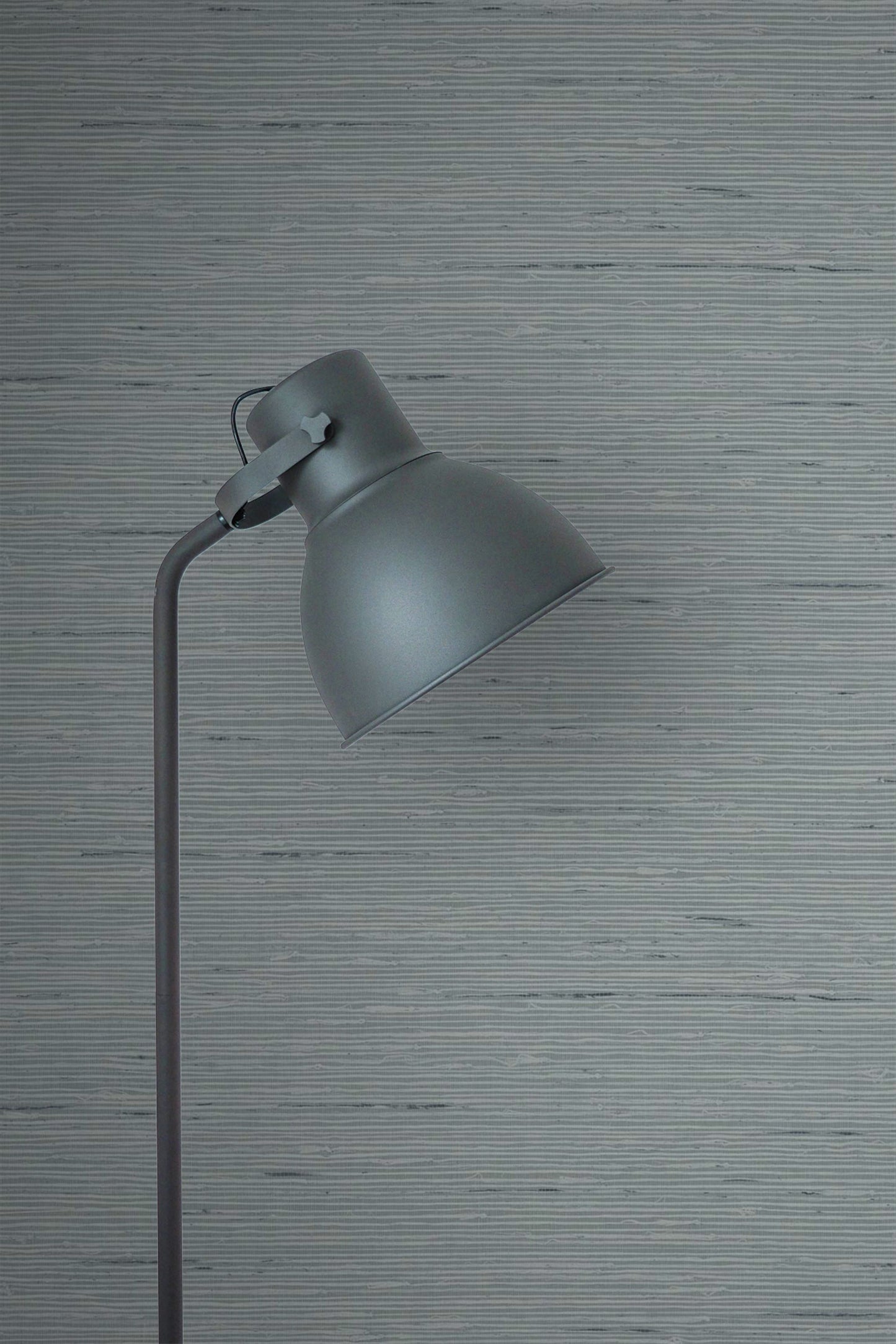 Gray floor lamp against a wall decorated with Templeton Gray Natural Weave Commercial & Vinyl.
