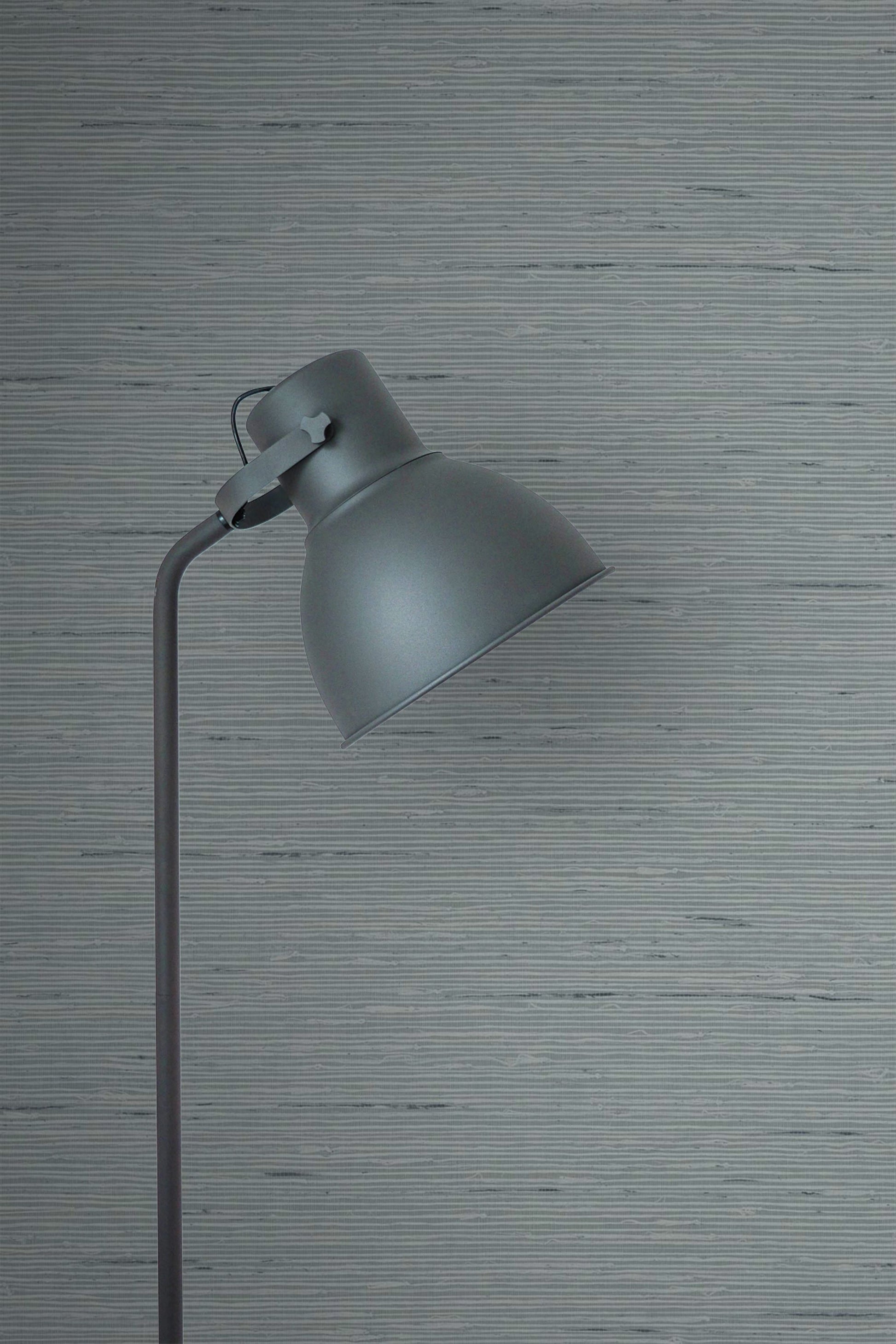 Gray floor lamp against a wall decorated with Templeton Gray Natural Weave Commercial & Vinyl.
