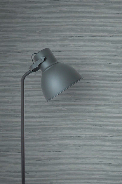 Gray floor lamp against a wall decorated with Templeton Gray Natural Weave Commercial & Vinyl.
