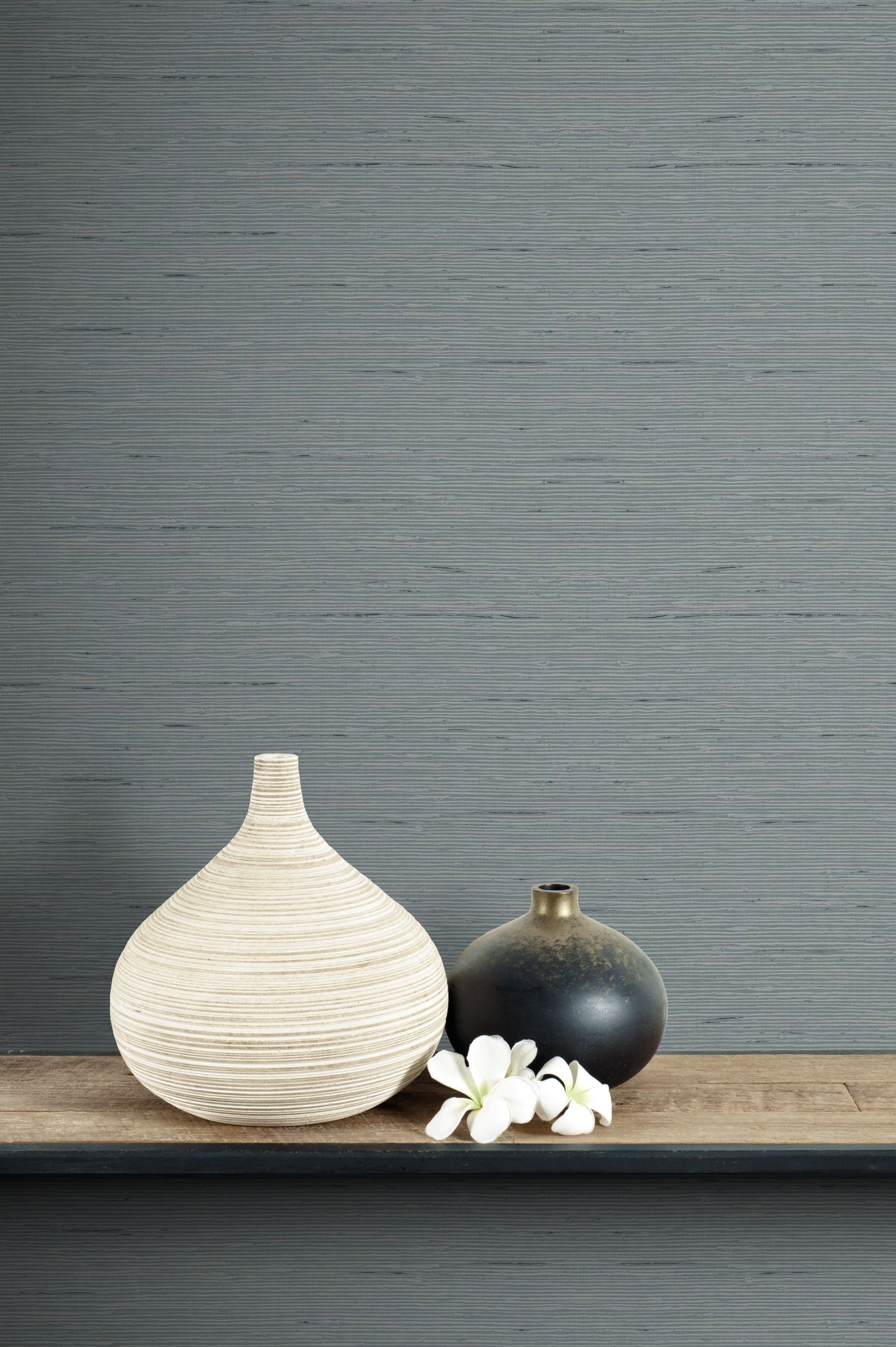 Two vases on a wooden surface with a wall decorated with Templeton Gray Natural Weave Commercial & Vinyl
 in the background.