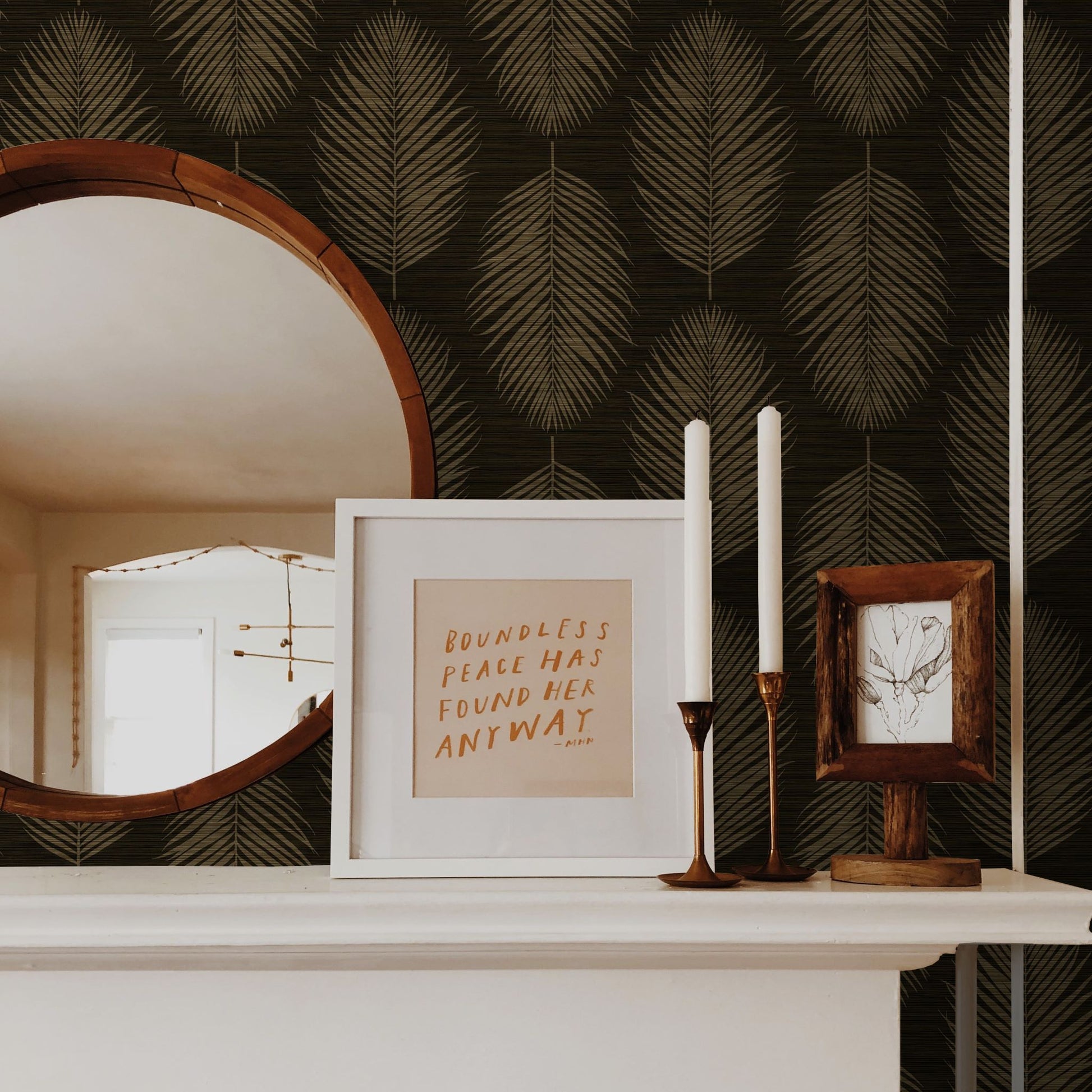Decorative shelf with framed text, candles, and mirror against a wall decorated with Brown Grasslands Leaf Commercial & Vinyl.
