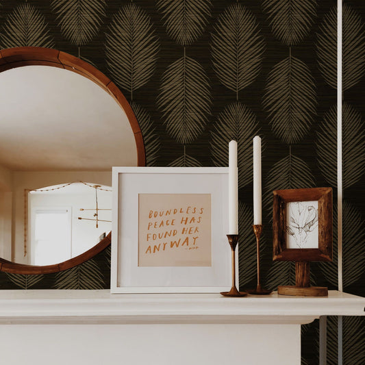 Decorative shelf with framed text, candles, and mirror against a wall decorated with Brown Grasslands Leaf Commercial & Vinyl.
