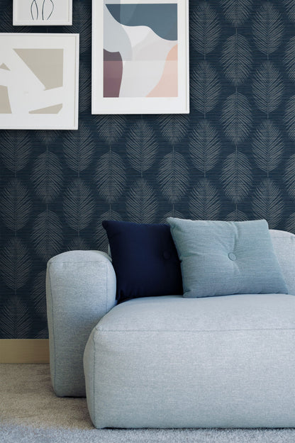 Gray sofa with blue and navy cushions against a wall decorated with Blue Grasslands Leaf Commercial & Vinyl.
