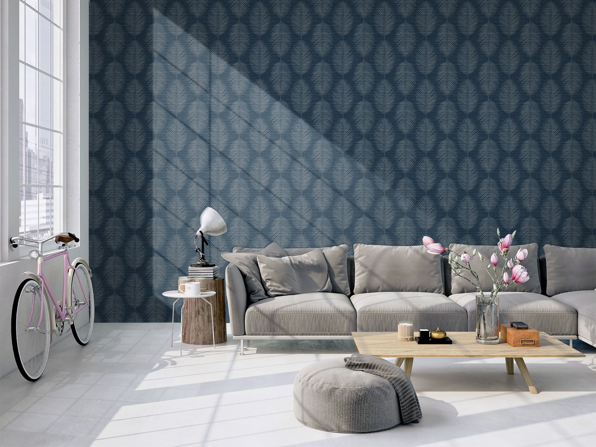 Modern living room with a gray sofa, coffee table, and bicycle against a wall decorated with Blue Grasslands Leaf Commercial & Vinyl.
