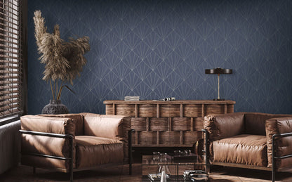Living room with brown leather sofa, wooden cabinet, and decorative elements against a wall decorated with Ink Blue Art Deco Geo Commercial & Vinyl.

