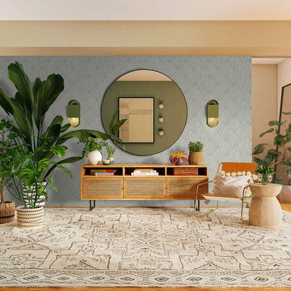 Modern living room with a wooden sideboard, round mirror, and decorative items and a wall decorated with Beige & Ash Art Deco Geo Commercial & Vinyl.
