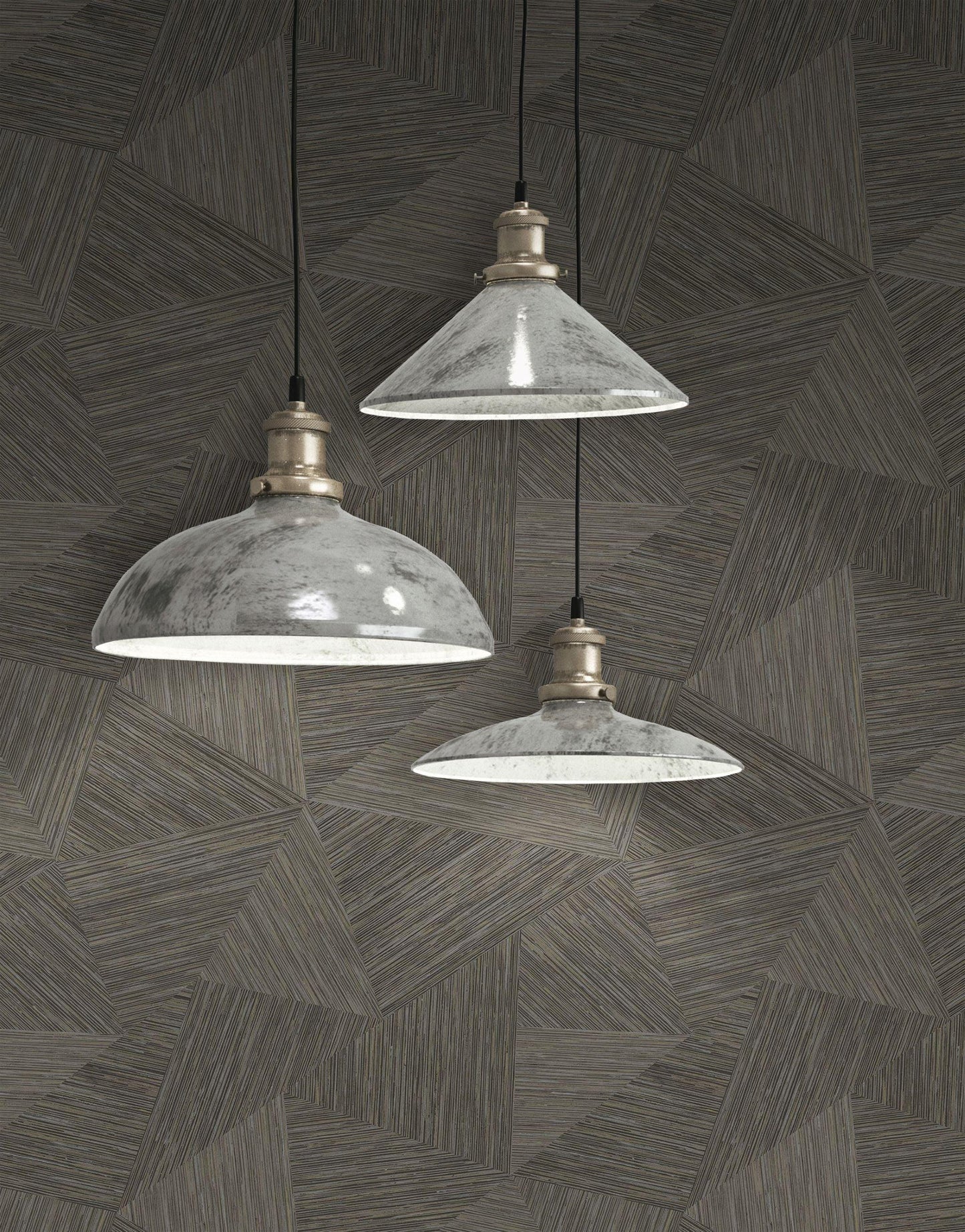 Three industrial-style pendant lights hanging against a wall decorated with Brown & Taupe Geometric Fibers Triangles Commercial & Vinyl.