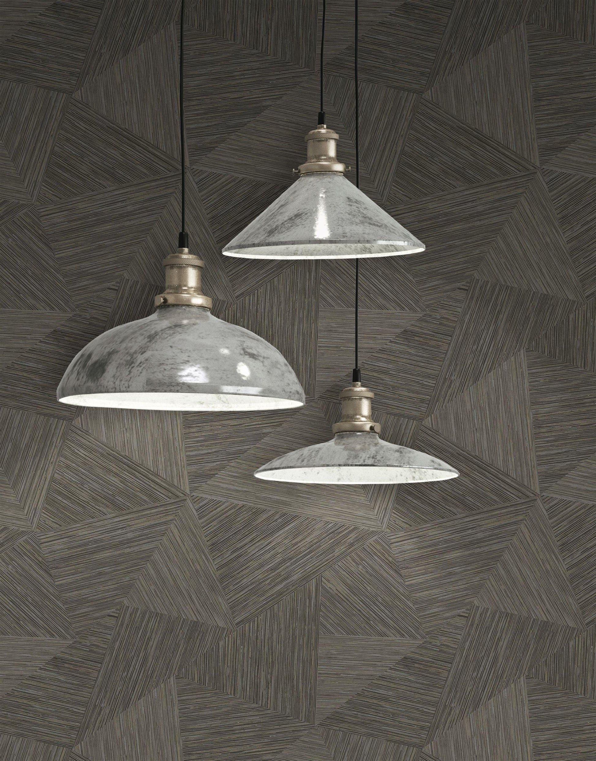 Three industrial-style pendant lights hanging against a wall decorated with Brown & Taupe Geometric Fibers Triangles Commercial & Vinyl.