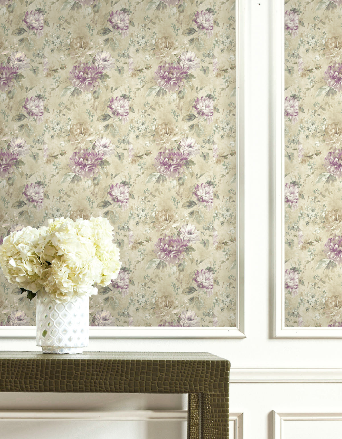 White vase with hydrangeas stands before Floral Wallpaper featuring a purple and beige graphic print.