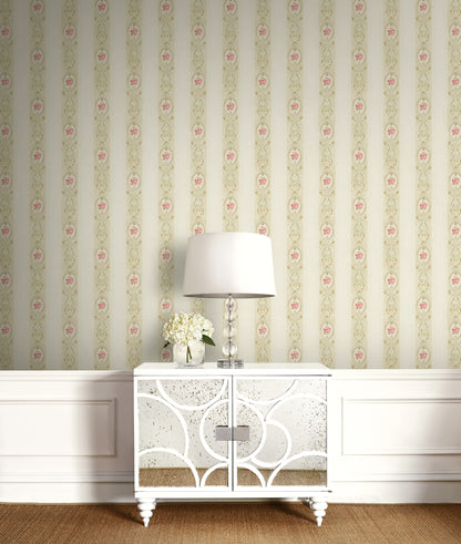 White cabinet with decorative patterns against a floral wallpapered wall.
