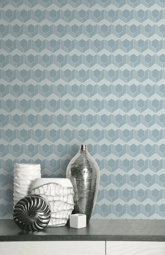 3D Hexagon Wallpaper in geometric blue with silver and white vases on a light gray surface.