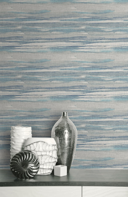 Decorative vases and a shell on a surface with a textured Bleu & Gray
Grasscloth Waves Wallpaper.