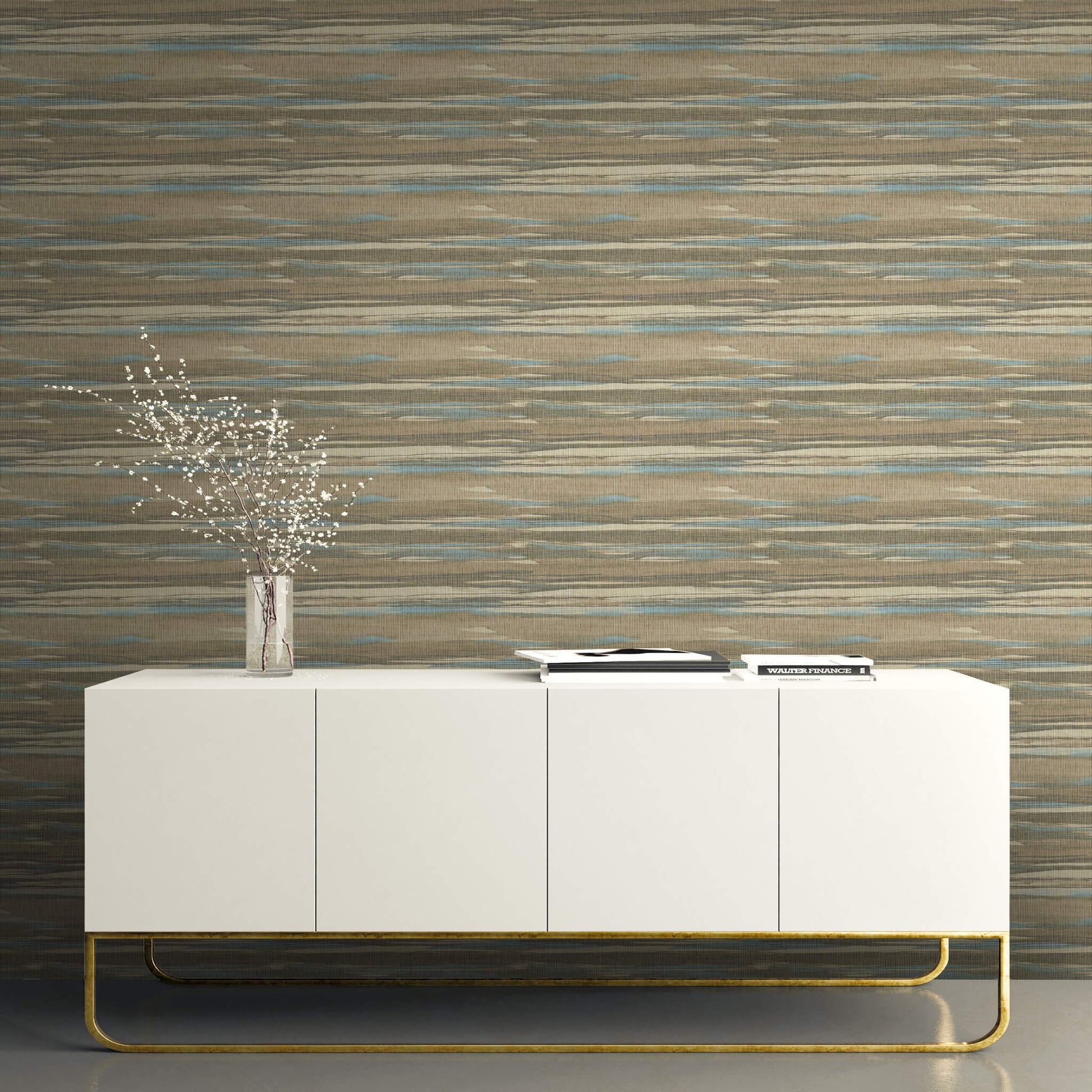 White sideboard with gold legs against a textured Brown & Bleu Grasscloth Waves Wallpaper.
