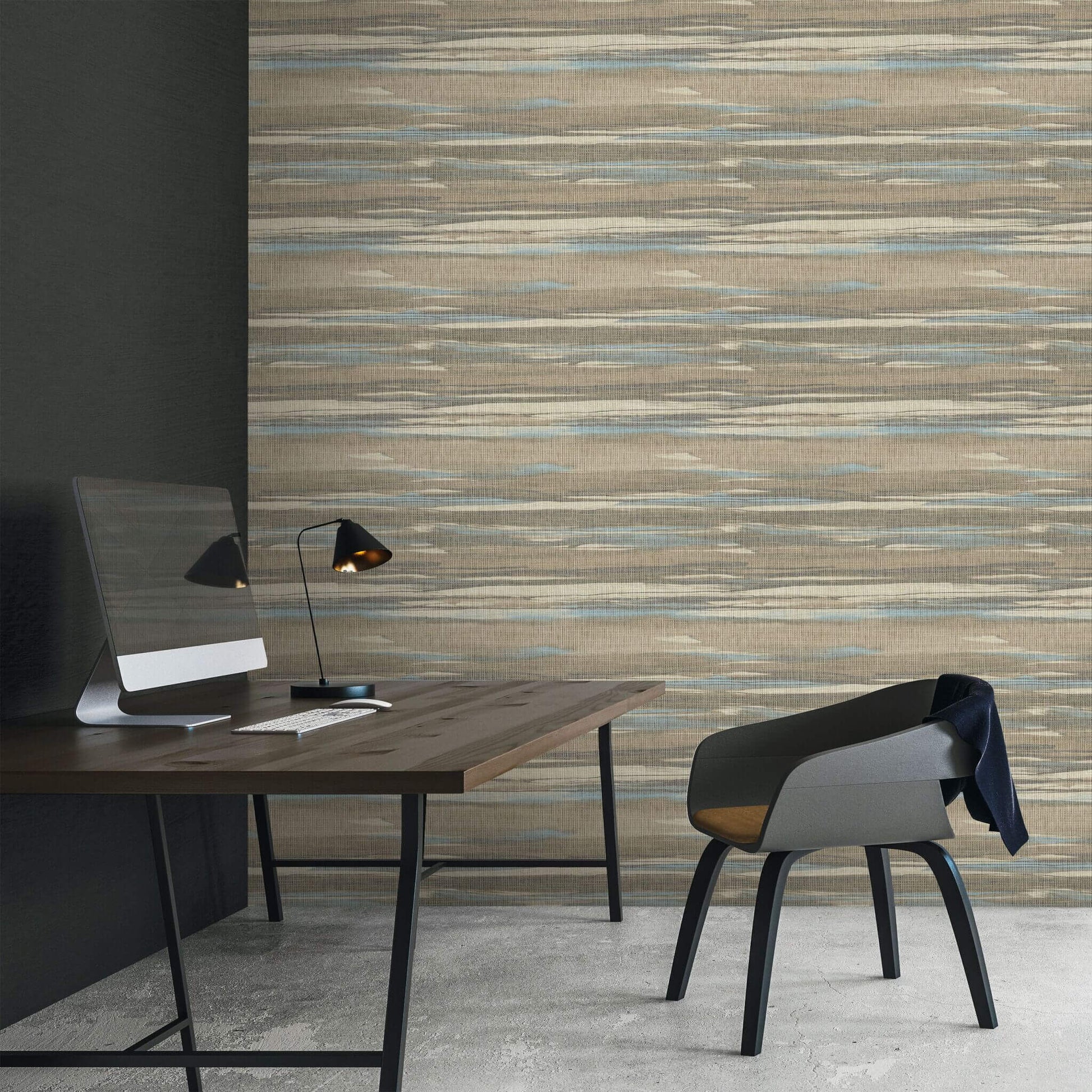 Modern office setup with a desk, chair, and lamp against a textured Brown & Bleu Grasscloth Waves Wallpaper.
