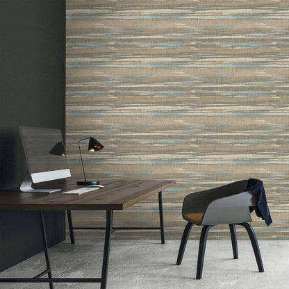 Modern office setup with a desk, chair, and lamp against a textured Brown & Bleu Grasscloth Waves Wallpaper.

